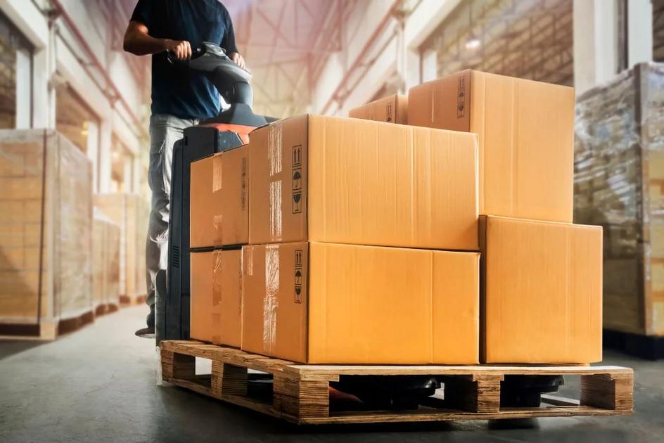 SSN fulfilment team moving palletised stock through a distribution warehouse